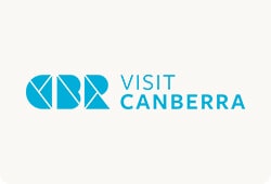 Visit Canberra - Canberra Guided Tours Visit Canberra logo showing stylised blue geometric 'CBR' shapes to the left of the words 'VISIT CANBERRA' in blue on a pale background.